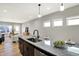 Open-concept kitchen featuring a granite countertop island with seating and a sink, adjacent to the living area at 1624 Prospect St, Indianapolis, IN 46203