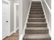 Carpeted stairway with painted handrail, leading to the next level of the home at 1624 Prospect St, Indianapolis, IN 46203