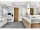 Elegant bathroom featuring dual vanities, marble finishes, and a glass-enclosed shower at 16246 Remington Dr, Fishers, IN 46037