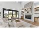 Bright living room features a modern fireplace, stylish decor, and a sliding glass door to the backyard at 16246 Remington Dr, Fishers, IN 46037