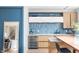 Modern wet bar with custom cabinetry, a wine fridge, and unique backsplash at 16246 Remington Dr, Fishers, IN 46037