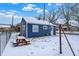 Blue house showcasing a snowy backyard, ideal for outdoor enjoyment and relaxation at 1651 Lawton Ave, Indianapolis, IN 46203