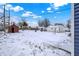 The backyard is covered in snow with a shed and a picnic table, providing ample space for outdoor activities at 1651 Lawton Ave, Indianapolis, IN 46203