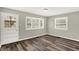Bedroom boasts wood-look floors, neutral walls, and a door to the outside at 1651 Lawton Ave, Indianapolis, IN 46203