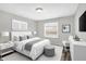 Bright bedroom featuring a queen bed, neutral decor, and sleek modern furnishings at 1651 Lawton Ave, Indianapolis, IN 46203
