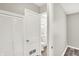 Hallway with closet leads to a bathroom, showcasing neutral walls and wood-look flooring at 1651 Lawton Ave, Indianapolis, IN 46203