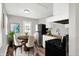 Modern kitchen with sleek appliances, stylish dining area and hardwood floors at 1651 Lawton Ave, Indianapolis, IN 46203