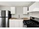 Kitchen featuring stainless steel appliances, wood countertops and white cabinetry at 1651 Lawton Ave, Indianapolis, IN 46203