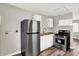 Kitchen featuring stainless steel appliances and white cabinets with butcher block countertops at 1651 Lawton Ave, Indianapolis, IN 46203