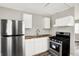 Updated kitchen with stainless steel appliances and ample cabinet space at 1651 Lawton Ave, Indianapolis, IN 46203