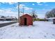 An exterior view of the property's shed with an open door, with snow on the ground at 1651 Lawton Ave, Indianapolis, IN 46203
