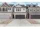 Charming townhouse showcases a two-car garage and neutral colors against a blue sky at 18712 Moray St, Westfield, IN 46074