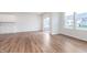 Open living room has wood floors, large windows, and sliding doors to the patio at 18712 Moray St, Westfield, IN 46074