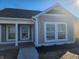 Charming, single-story home featuring board and batten siding, white trim, and a covered front porch at 1967 Hovey St, Indianapolis, IN 46218