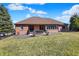 Expansive backyard with well-maintained lawn, patio seating, and a classic brick home exterior at 2110 Cheviot Ct, Greenwood, IN 46143