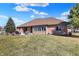 Wide backyard view showcasing a well-manicured lawn, patio, and brick home exterior under a sunny sky at 2110 Cheviot Ct, Greenwood, IN 46143
