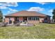 Large backyard featuring a patio with outdoor seating and views of the brick home's rear exterior at 2110 Cheviot Ct, Greenwood, IN 46143