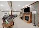 Basement featuring stone fireplace, large screen TV, and comfortable seating at 2110 Cheviot Ct, Greenwood, IN 46143