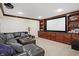 Basement home theater with large screen, built-in cabinets, and leather seating at 2110 Cheviot Ct, Greenwood, IN 46143