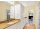 Bright bathroom featuring a single vanity, granite countertops and a large mirror, enhancing the room's aesthetic at 2110 Cheviot Ct, Greenwood, IN 46143