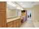 Spacious bathroom featuring double vanities, granite countertops, and a television for added convenience at 2110 Cheviot Ct, Greenwood, IN 46143