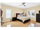 Bright bedroom with a comfortable bed, hardwood floors, and a window overlooking the outdoor scenery at 2110 Cheviot Ct, Greenwood, IN 46143
