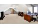 A finished bonus room with an angled ceiling features a seating area, desk, and TV at 2110 Cheviot Ct, Greenwood, IN 46143