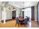 Sophisticated dining area with a wooden table, upholstered chairs, and large windows for natural light at 2110 Cheviot Ct, Greenwood, IN 46143