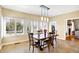 Dining room with a wooden table, chairs, and large windows at 2110 Cheviot Ct, Greenwood, IN 46143
