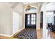 Grand entryway showcasing double doors, a decorative rug, and archways leading to other living spaces at 2110 Cheviot Ct, Greenwood, IN 46143