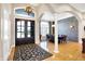 Elegant entryway featuring double doors, a decorative rug, and access to the dining room at 2110 Cheviot Ct, Greenwood, IN 46143