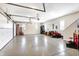 Spacious garage with epoxy floors, bright lighting, and space for vehicles and storage at 2110 Cheviot Ct, Greenwood, IN 46143
