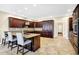 Kitchen featuring a center island with bar seating, granite counters, custom cabinets and tile flooring at 2110 Cheviot Ct, Greenwood, IN 46143