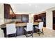 A kitchen with a center island that features bar stool seating, granite counters, and custom wood cabinets at 2110 Cheviot Ct, Greenwood, IN 46143