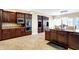 Modern kitchen featuring dark wood cabinets, granite countertops, and a dining area at 2110 Cheviot Ct, Greenwood, IN 46143
