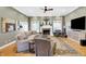 Spacious living room with a fireplace, hardwood floors, and a large sectional at 2110 Cheviot Ct, Greenwood, IN 46143