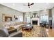 Comfortable living room with a fireplace, large windows, and neutral tones at 2110 Cheviot Ct, Greenwood, IN 46143