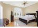 Inviting main bedroom with large arched window, hardwood floors and modern furnishings at 2110 Cheviot Ct, Greenwood, IN 46143