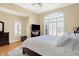Spacious main bedroom with large arched window providing lots of natural light and hardwood flooring at 2110 Cheviot Ct, Greenwood, IN 46143