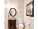 Charming powder room with custom vanity, granite countertop and decorative mirror at 2110 Cheviot Ct, Greenwood, IN 46143