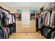 Large walk-in closet with custom shelving, hanging rods, and drawers for organized storage solutions at 2110 Cheviot Ct, Greenwood, IN 46143