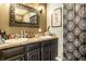 Bathroom featuring double sinks, stylish mirror, and patterned shower curtain at 2758 S Lyons Ave, Indianapolis, IN 46241