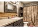 Bathroom featuring a single sink and shower with dark brown patterned shower curtain at 2758 S Lyons Ave, Indianapolis, IN 46241