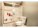 Bathroom featuring a tub with glass doors, a white toilet, and tiled walls at 2758 S Lyons Ave, Indianapolis, IN 46241
