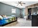 Bedroom with neutral carpet, a ceiling fan, one window, and closet with open doors at 2758 S Lyons Ave, Indianapolis, IN 46241