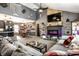 Open living room with vaulted ceilings, a fireplace, a large sectional, and a coffee table at 2758 S Lyons Ave, Indianapolis, IN 46241