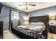 Main bedroom featuring a large tufted bed, side tables, soft carpet, and neutral decor at 2758 S Lyons Ave, Indianapolis, IN 46241