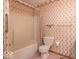 Full bathroom featuring a tub, shower, and toilet with decorative wallpaper at 2979 Colony Lake E Dr, Plainfield, IN 46168