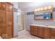 Bathroom featuring a large mirror, shower, and storage at 2979 Colony Lake E Dr, Plainfield, IN 46168