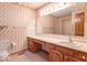 Bathroom featuring a lengthy countertop with wallpaper and paneled cabinets at 2979 Colony Lake E Dr, Plainfield, IN 46168